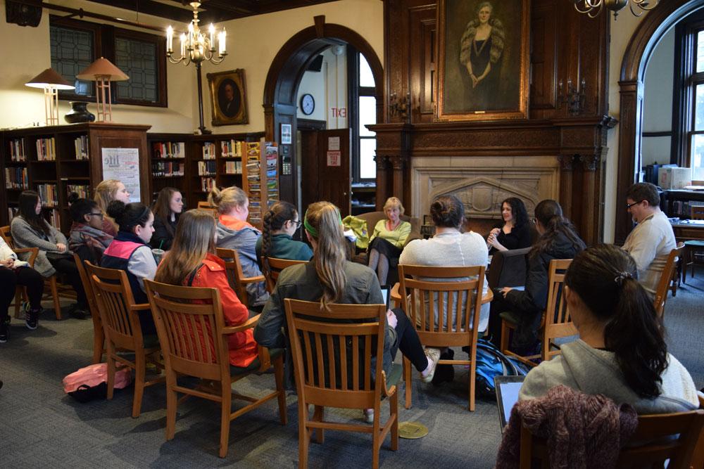 students attending a talk by Wilkinson poet in the library